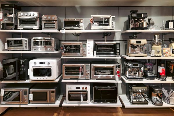 A room filled with lots of different types of microwaves